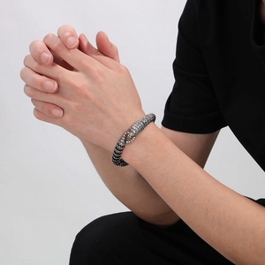 Vintage silver snake bracelet for men featuring detailed scale textures on a polished metal band