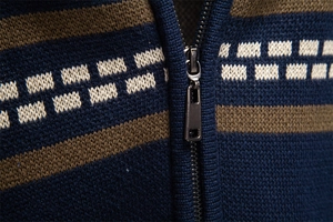 Detailed close-up of heavy-duty metal zipper and navy blue knit fabric with brown stripes