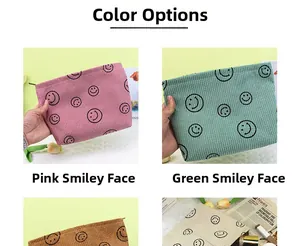 Multiple color options of corduroy cosmetic bags featuring a smiling face pattern