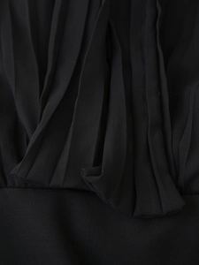 Detailed close-up of the black pleated chiffon fabric texture on this elegant dress