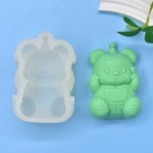 DIY cartoon bear silicone mold for candles, soap, and cake baking on a blue background
