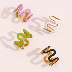 Detail of colorful enamel wave rings in purple white lime and black with water droplets
