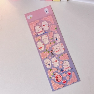 Detailed view of pink rabbit and cherry blossom stickers with holographic laser finish