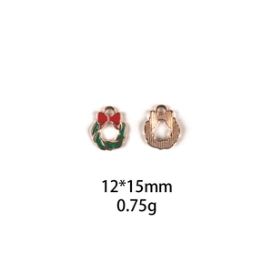 Detail showing 12x15mm Christmas wreath pendant with red bow and gold metal texture
