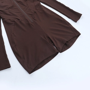 Detail of coffee brown slim fit jumpsuit featuring zipper waist and tight knit fabric