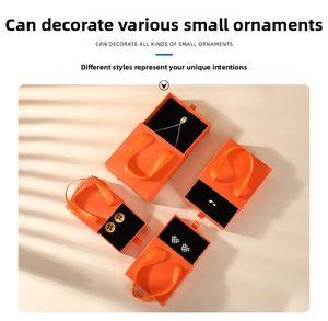Detail of orange drawer jewelry box with ribbon handle and soft black sponge insert