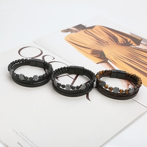 Dettaglio macro del bracciale multistrato in pelle con pietra occhio di tigre e chiusura in lega