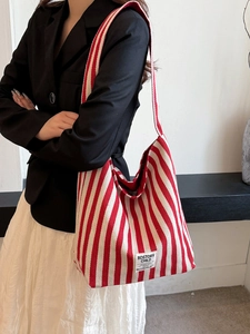 Chic red and white striped canvas tote bag styled with a minimalist retro outfit