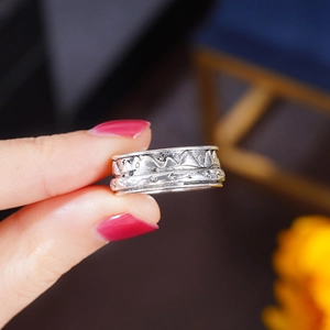 Macro shot of retro silver ring featuring continuous mountain relief with oxidized finish