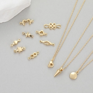 14K gold plated jewelry charms set with star and heart pendants on stone base