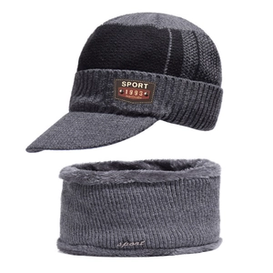 Detailed texture of thick fleece lining on grey knitted beanie and neck warmer set