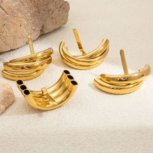 Detailed macro of gold plated 18K stainless steel hair accessory with U-shaped curved tubes