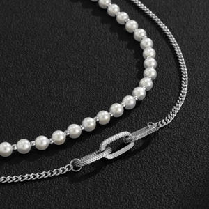 Minimalist double layer necklace with white pearls and silver metal chain on black base
