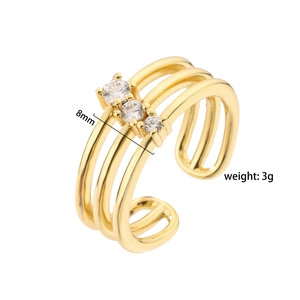 Detailed view of golden triple-layered ring with zircon stones, 8mm width and 3g weight