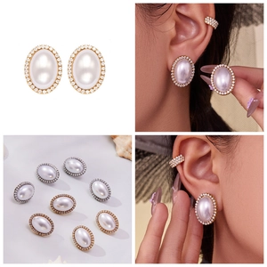 Detailed view of oval pearl earrings with zircon inlay and matching ear cuffs