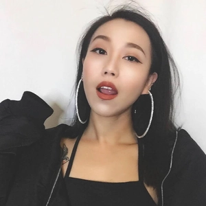Sparkling oversized silver crystal hoop earrings with rhinestones worn by a model