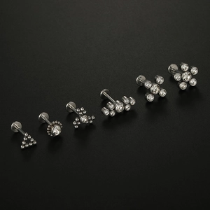 Detailed macro view of 16G surgical steel piercing studs with cubic zirconia clusters