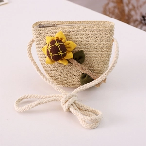 Detailed view of kids' straw crossbody bag with sunflower doll and cotton rope strap