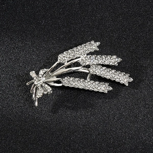 Detailed macro view of silver wheat brooch with shimmering crystal rhinestones