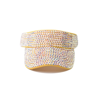 Detail of yellow sun visor hat with sparkling colorful rhinestones on the brim and band