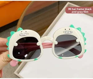 Detail of dinosaur cartoon sunglasses for kids with off-white frames and grey lenses