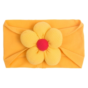 Detailed view of yellow ribbed fabric flower on an orange newborn nylon headband