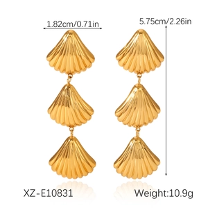 Detailed view of triple shell drop earrings in 18K gold plated steel with measurements