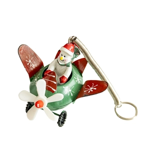 Christmas snowman flying a green metal plane ornament with a hanging spring hook