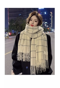 Detailed close-up of cream black checkered scarf with soft fringe and woven brand label
