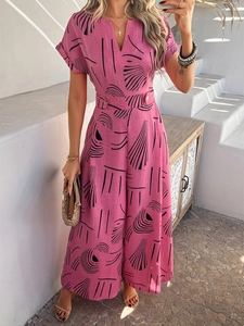 Detail of pink floral jumpsuit featuring V-neck, short sleeves, and belted wide-leg design