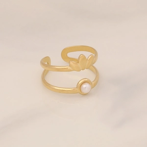 Detail of gold double-layer ring featuring flower petals and a white pearl accent