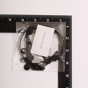 Detailed scale measurement of gothic cross chain jewelry in retail packaging
