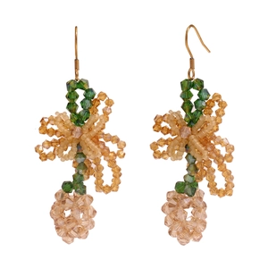Handmade beaded drop earrings in green and amber tones with gold hooks on white base
