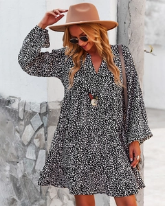 Detail of V-neck long sleeve dress with black and white polka dots in street style