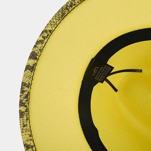 Detailed interior of a yellow felt fedora showing the cotton label and snake print brim