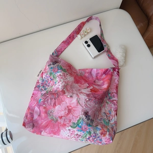 Close-up of pink floral cotton tote bag featuring large dahlia patterns and brand label