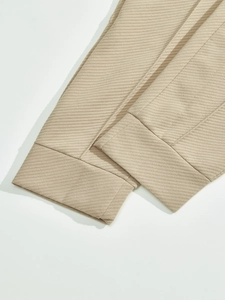 Detail of beige twill fabric cuffs with high-density stitching and clean texture