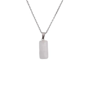 Detail view of a white cylindrical stone pendant with a delicate silver metal chain