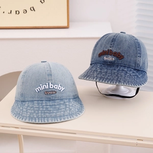Close-up of denim baby bucket hats in light and dark blue with embroidered 3D letters