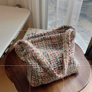 Close-up of vibrant multi-color tweed woven tote bag with rich knit texture and soft handle