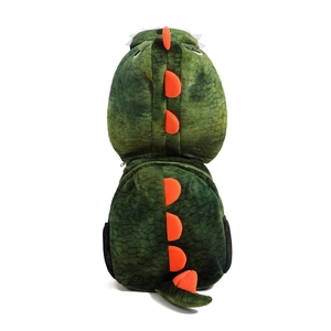 Cute green plush dinosaur backpack for kids featuring soft orange fins and tail on white back