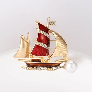 Detail of sailboat brooch in gold alloy with red enamel, rhinestones and white pearl