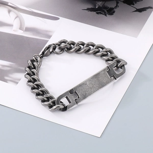 Macro shot of industrial style stainless steel curb chain bracelet with blank metal plate