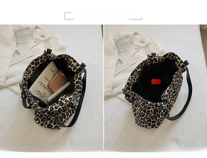 Detail of leopard print tote bag interior capacity with leather strap and metal ring