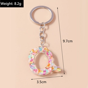 Detailed view of Letter Q keychain with colorful sequins and dimensions 9.7cm by 3.5cm