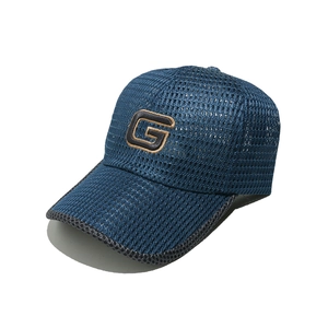 Detail of navy blue breathable mesh baseball cap with embroidered G logo for summer wear