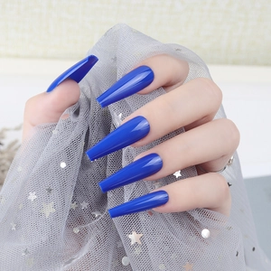 Detail of royal blue long coffin press-on nails with a high-gloss UV coating finish
