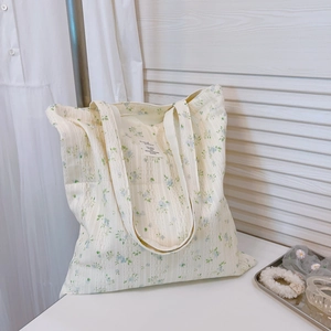 Floral cotton tote bag with blue flowers and lace texture on a minimalist background