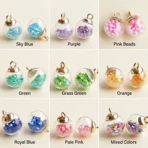Close-up of star sequins inside colorful glass ball charms with gold rings for DIY jewelry