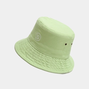 Detail of lime green cotton bucket hat featuring white S embroidery and metal eyelets